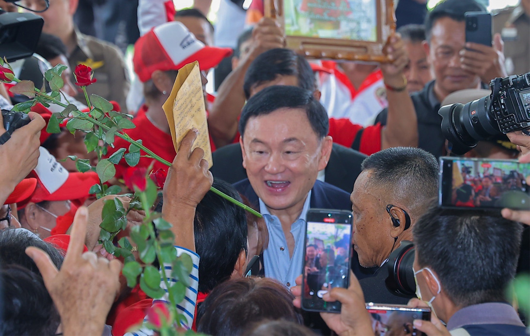 Thaksin Gets Warm Welcome by His Supporters at Pheu Thai HQ